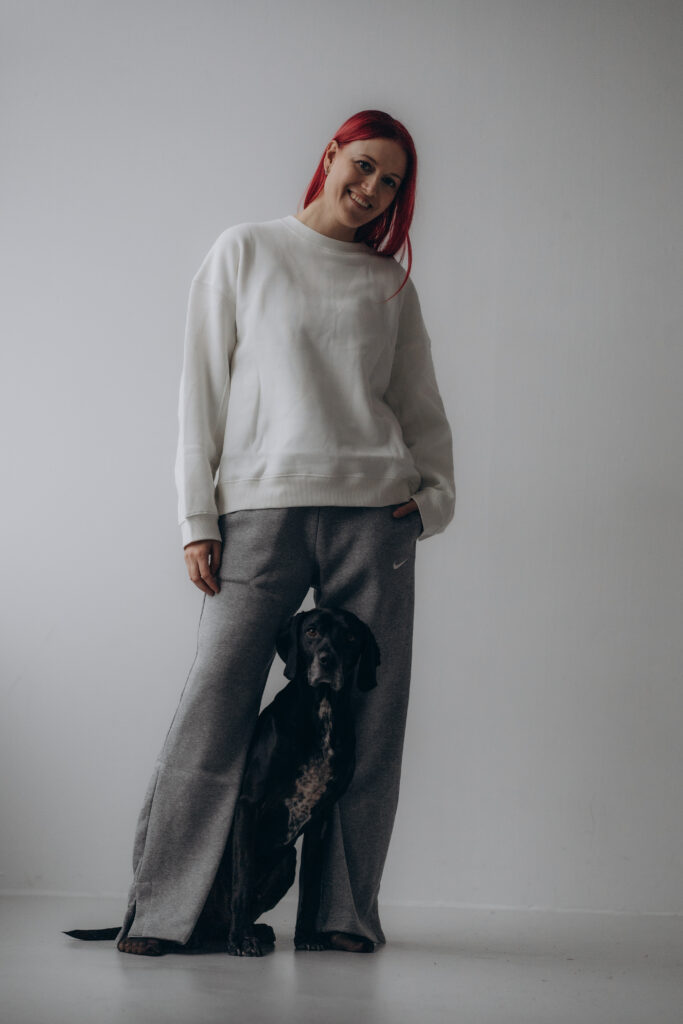 Gina standing with her dog