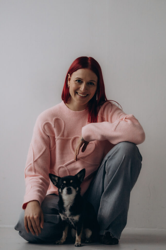 Gina smiling with a small dog
